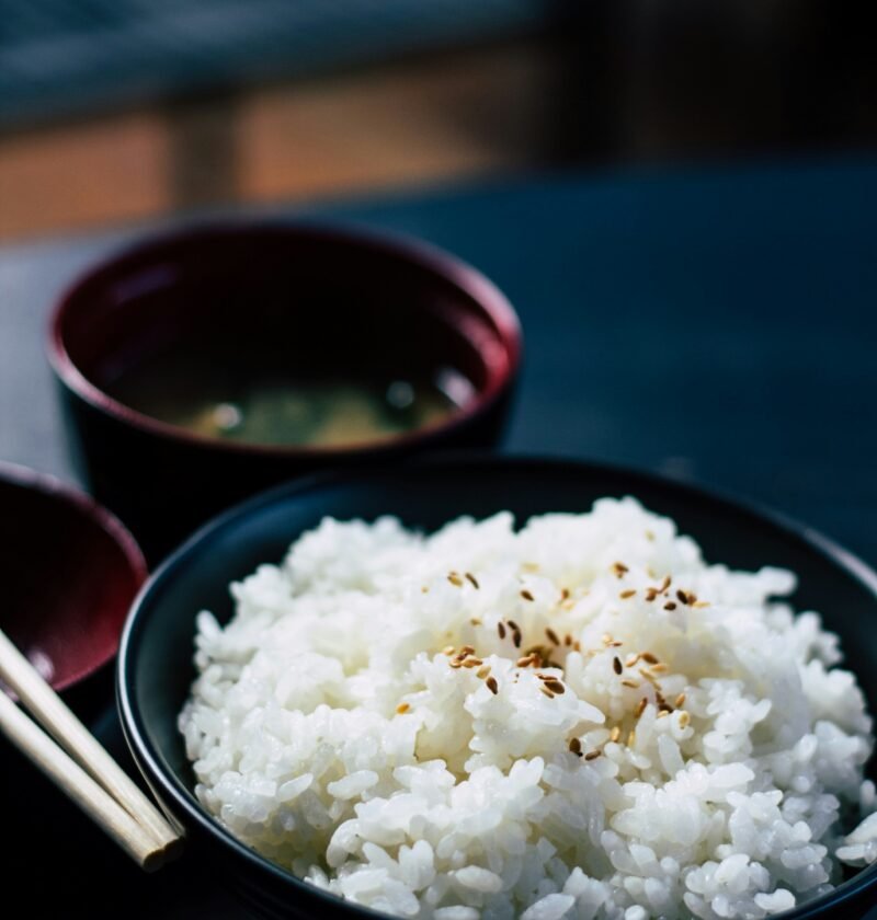 rice with sesame in black bowl